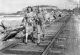 'Women walking along the tramline at Nobbys Breakwater, Newcastle, 1930s'